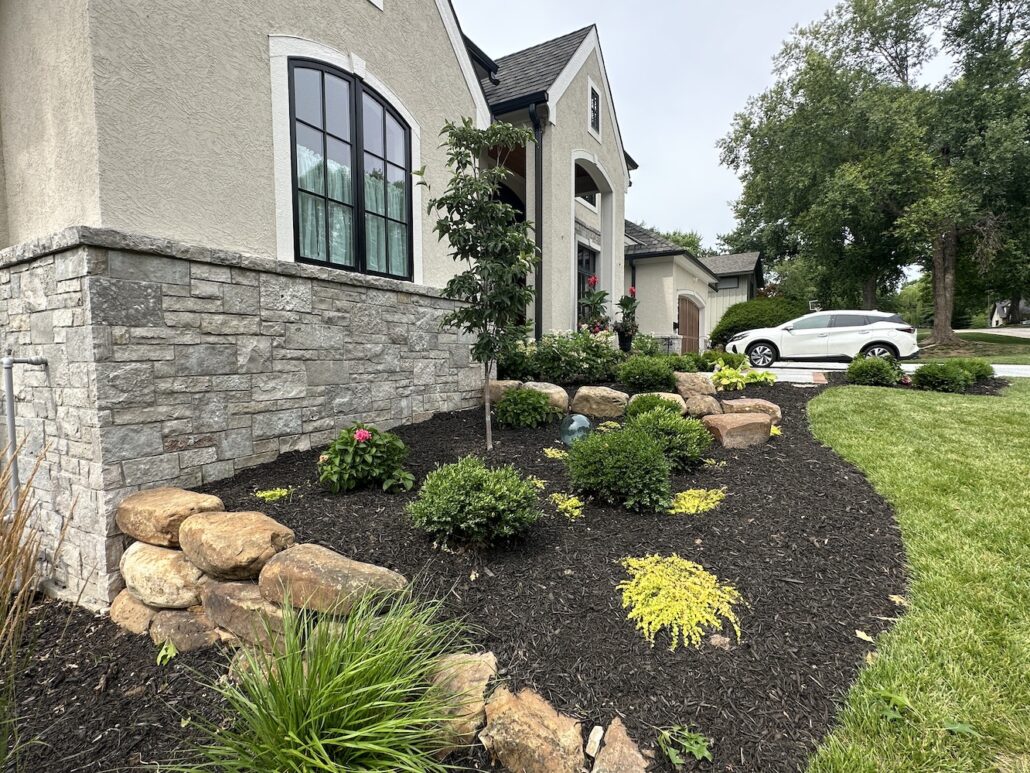 Mulch in landscape beds protects plantings during winter.